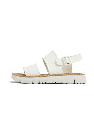 White open-toe sandal with two wide straps, adjustable ankle strap with buckle, cork footbed, and thick white rubber sole.