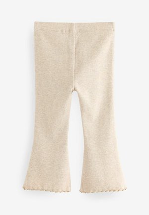 Beige geribbelde uitlopende legging met een gegolfde zoom. Gemaakt van zachte stof, met een rekbare tailleband en een aansluitende pasvorm.