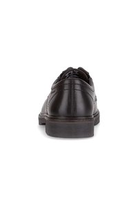 Zwarte leren dresschoenen met een gladde afwerking, ronde neus, subtiele stikdetails en een lage, stevige zwarte rubberen hak.