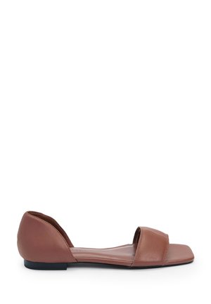 Brown leather flat shoes with an open back and two wide straps over the forefoot. The sole is flat and contrasts with the soft leather texture.
