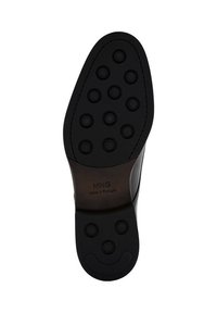 Black rubber shoe sole featuring round grip patterns, embossed branding, and a curved edge design. Made in Portugal.