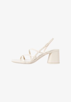 Beige Riemchen-High Heels mit einer abgerundeten offenen Zehenpartie und einem mittelhohen Blockabsatz. Mit verstellbarem Knöchelriemen und glatter, glänzender Oberfläche.