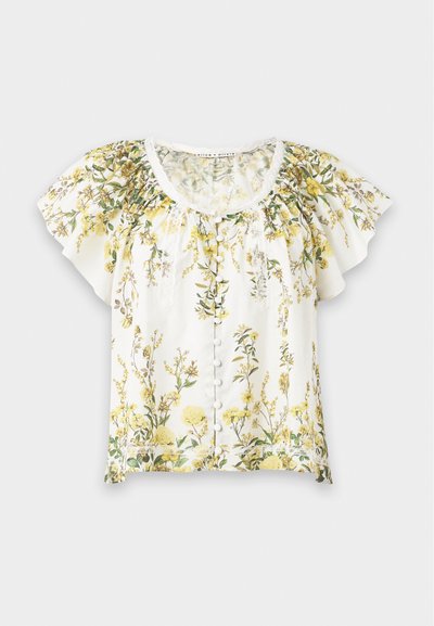 Blouse blanche à manches courtes avec imprimé floral jaune et vert, encolure ronde, boutons sur le devant et manches amples à volants.
