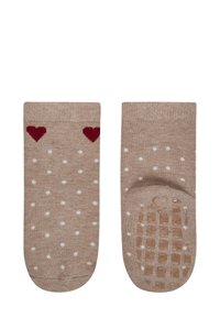 Beige socks with white polka dots and red heart patterns at the top. Textured grip sole for added traction.