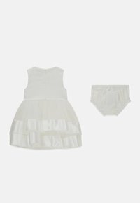 Weißes Kleid mit figurbetontem Oberteil, mehrlagigem Tüllrock und Satinvolants. Inklusive passendem weißem Windelüberzug mit elastischem Bund.