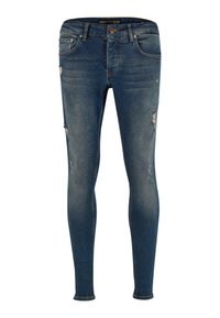 Jean skinny en denim bleu délavé avec détails usés. Comprend cinq poches et une fermeture par bouton. Texture lisse et coupe ajustée.
