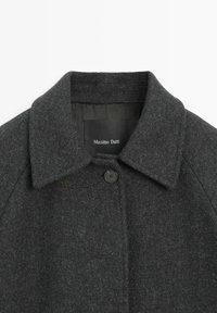 Dark gray wool coat featuring a notched collar, single button closure, and soft texture. Label visible inside reads "Massimo Dutti."