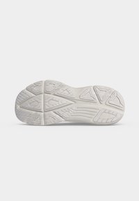 Semelle de chaussure en caoutchouc blanc avec des motifs de bande de roulement détaillés et le nom de la marque Saucony embossé au centre.