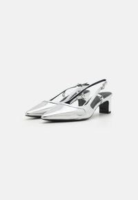 Strieborné slingback opätky s špicatými špičkami, lesklým povrchom a malým čiernym blokovým podpätkom. Nastaviteľný remienok pre bezpečné uchytenie.