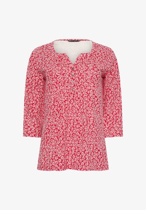 Tunica rossa a maniche lunghe con motivo floreale bianco e colletto a V con bottoni.