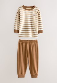 Chemise à manches longues rayée crème et marron avec poignets côtelés, associée à un pantalon marron à taille élastique. Présente une petite étoile brodée.