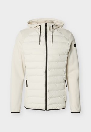 Veste blanche à capuche avec devant matelassé, manches lisses, fermeture éclair noire et cordons, poches latérales zippées.