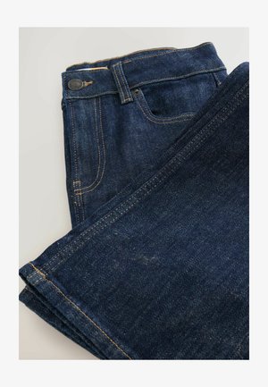 Dark blue denim jeans folded, featuring a classic five-pocket design, orange stitching, and a metal button at the waistband.