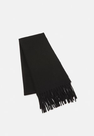 Écharpe noire en laine pliée avec des extrémités à franges, texture lisse et logo embossé subtil près du bord sur un fond blanc.