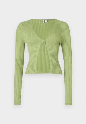 Zelena rebrasta majica dugih rukava s V-izrezom i vezanjem sprijeda. Glatka tekstura, kroj koji se prilagođava tijelu i skraćeni dizajn.