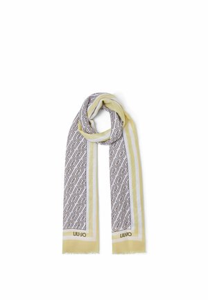 Sciarpa giallo chiaro e bianca con motivi geometrici intrecciati e testo "Liu Jo" vicino alle estremità frangiate, piegata a loop.
