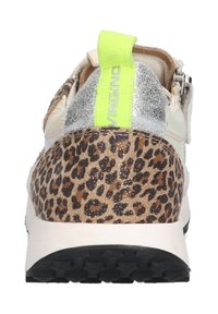 Sneaker features a leopard print heel, cream body, silver accents, and neon green pull tab. Textured materials with a rubber sole.