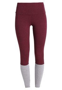 Leggings bordeaux con un alto punto vita, caratterizzati da pannelli grigi alla caviglia. Il tessuto ha un aspetto morbido e strutturato.