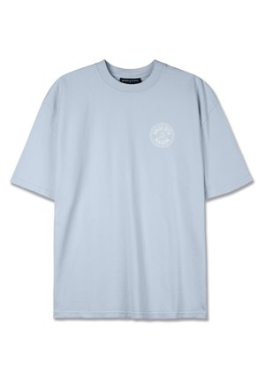 Light blue cotton t-shirt with a round neck and short sleeves. Features a small white circular logo on the left chest area.