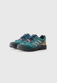 Chaussures de trail en teal et noir avec des accents gris et des détails orange. Elles disposent d'un dessus en mesh, d'une semelle robuste et de lacets bleus pour un ajustement sûr.