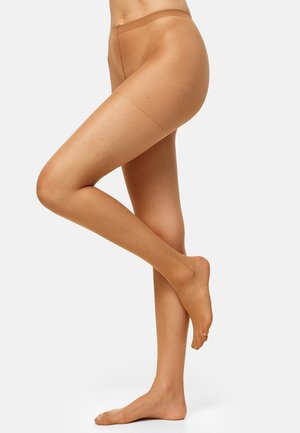 Collant beige con finitura opaca, caratterizzati da una texture liscia e una fascia larga in vita, indossati su una gamba in piedi con un piede nudo.