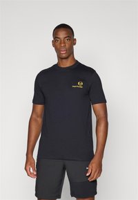 Black short-sleeve t-shirt made of cotton, featuring a small yellow logo on the left chest. Simple design with a crew neck.