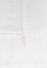 White cotton muslin fabric with a textured grid pattern, featuring a frayed edge at one corner. Smooth and lightweight.
