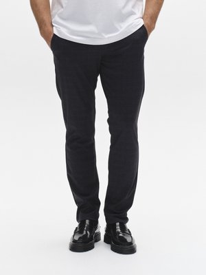 Marinblå skräddarsydda byxor i ett texturerat tyg, smal passform, med sidofickor, bärs med svarta polerade skor och en vit t-shirt.