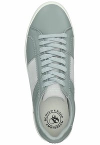 Light gray sneakers featuring smooth leather and suede sections, flat laces, a rounded toe, and a white rubber sole. Logo printed inside.