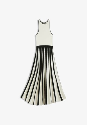Ærmeløs sort og hvid kjole med tætsiddende krop og udflaret plisseret nederdel med lodrette sorte striber på hvid baggrund.