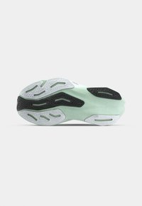 Sports shoe outsole with rubber components; features a mint green midsole, textured white and black rubber tread patterns, curved design.