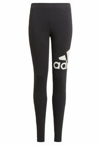 Leggings negros de tela elástica con cintura alta. Presentan un gran logo blanco de Adidas en el muslo izquierdo.