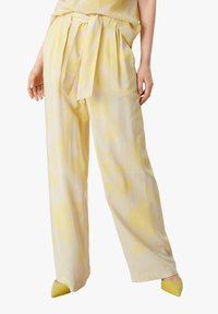 Yellow floral patterned wide-leg pants made of lightweight fabric, featuring a self-tie belt and a relaxed fit.