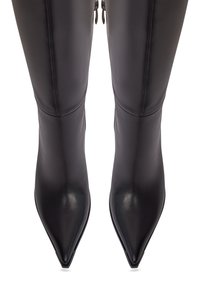Bottes en cuir noir, au-dessus du genou, avec des pointes pointues, une texture lisse et des fermetures éclair sur les côtés. Design élégant et ajusté qui accentue la forme des jambes.