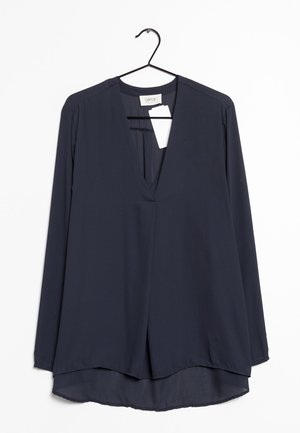 Blouse marine à manches longues en tissu léger, avec un décolleté en V profond, une coupe décontractée et un design d'ourlet asymétrique.