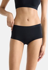 Mustat puuvillasekoitteiset hipsterit, joissa on sileä pinta ja leveä joustovyö, ja vyötärönauhassa on logo.