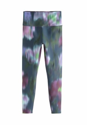 Høj talje leggings med et sløret akvarelblomstermønster i nuancer af blå, lilla, grøn og pink på en hvid baggrund.