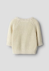 Ljusbeige stickad tröja med ett strukturerat ribbmönster, korta ärmar och en rund halsringning med ribbade muddar och nederkant.