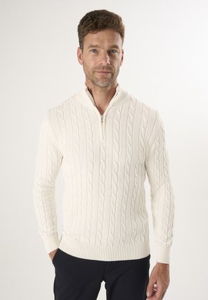 Cremfarbener Kabelstrickpullover mit Reißverschluss, gerippten Bündchen und Saum. Verfügt über ein strukturiertes Muster und einen taillierten Schnitt.