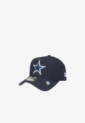 Dark blue baseball cap with white and navy star logo on front, curved brim, and adjustable strap, branded with NFL and New Era logos.