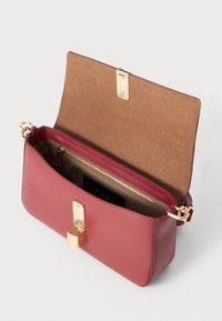 Rectangular burgundy leather handbag with a smooth texture, gold hardware, zip pocket, and a soft brown interior.