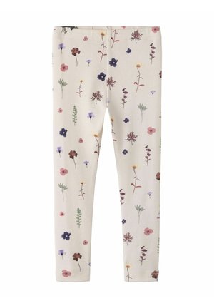 Leggings in roomkleur met een patroon van kleine, meerkleurige wilde bloemen en groene bladeren gelijkmatig verdeeld.