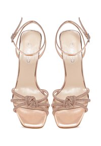 Sandali con tacco open-toe in metallizzato rosa oro, caratterizzati da cinture intrecciate testurizzate e un design elegante con punta quadrata e chiusura alla caviglia.