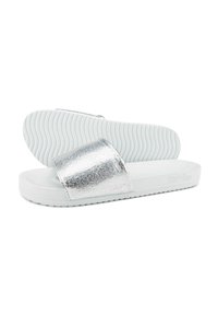White flip-flop sandals with a shiny silver cracked strap, soft textured footbed, and ribbed white outsole for traction.