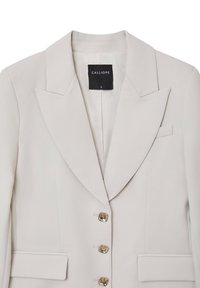 Helles beiges Blazer mit einem reverkragen, einreihigem Design und vier goldfarbenen Knöpfen. Verfügt über eine Brusttasche und Seitentaschen.