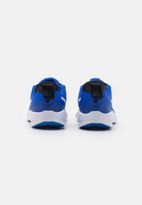 Blue athletic shoes with a mesh upper, white accents, and a black heel tab. Features a cushioned sole and branding on the back.