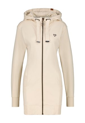 Giacca hoodie color crema con zip, due tasche laterali, polsini a coste, cappuccio regolabile con cordino e un piccolo logo a forma di cuore sul petto.