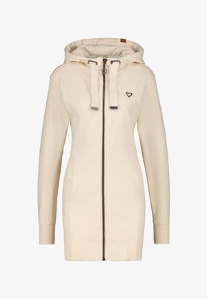 Giacca hoodie color crema con zip, due tasche laterali, polsini a coste, cappuccio regolabile con cordino e un piccolo logo a forma di cuore sul petto.