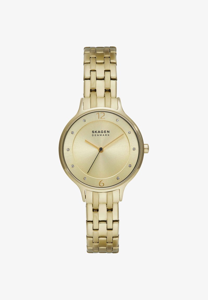 Gold-tone Skagen wristwatch with linked metal band, round face, crystal hour markers, and slim gold hands showing 10:08:38.