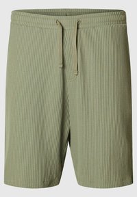 Gröna ribbade shorts med elastisk midja, utrustade med dragsko, och en avslappnad passform. Materialet är strukturerat och lätt.